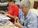 Participants at the ARRL Teachers Institute session in Dayton, Ohio, assemble robotic devices.